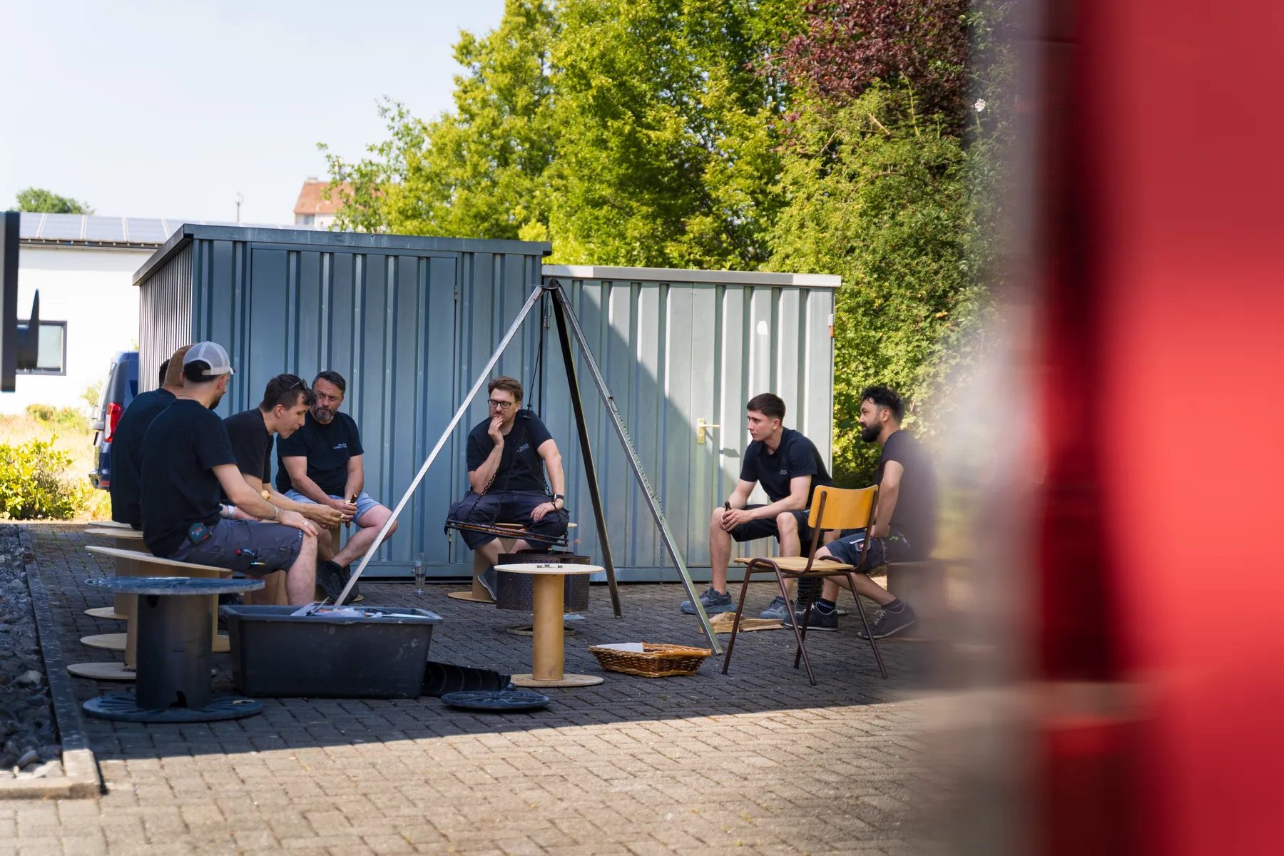The team at the fire bowl behind the warehouse